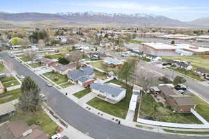Aerial overview of property's location featuring mountains and nearby suburban area