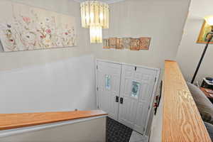 Foyer featuring suspended lighting