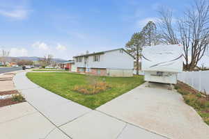 View of property exterior featuring a residential view and a mountain view