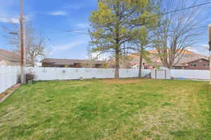 Fenced backyard with a storage shed
