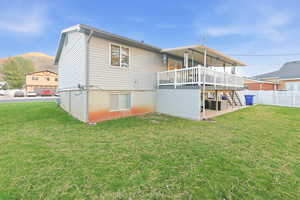 Rear view of property with a deck and a patio