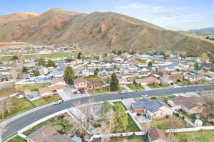 Aerial overview of property's location with nearby suburban area and a mountain backdrop