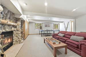 Living area featuring light colored carpet, a fireplace, and recessed lighting