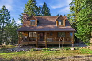 View of front of house with a porch and a chimney