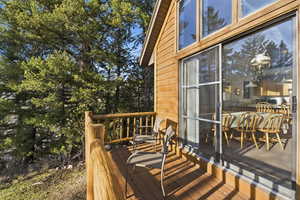 Deck featuring view of wooded area