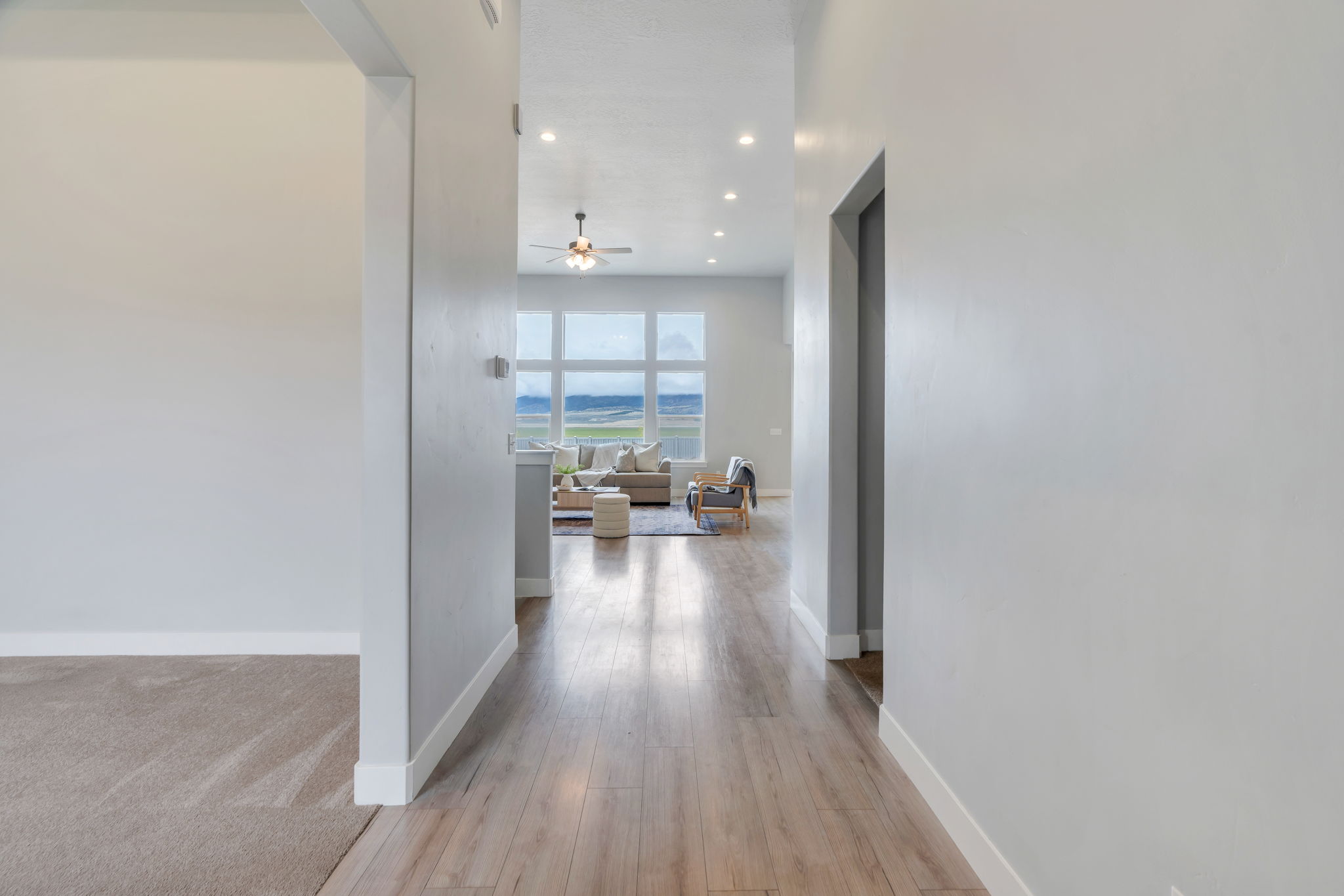 Corridor with light wood finished floors and recessed lighting