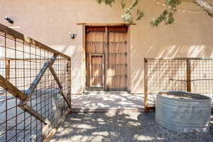 Doorway to property with stucco siding and a patio