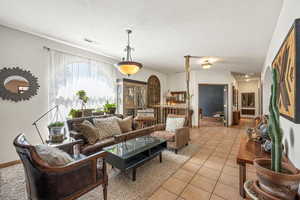 Living room featuring light tile patterned floors and a textured ceiling