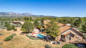 View from above of property with a pool and a mountain backdrop