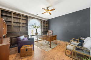 Office area featuring a ceiling fan and wood-type flooring