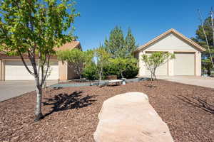 View of front of home featuring a garage, concrete driveway, and brick siding