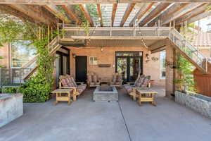 View of patio with a pergola, an outdoor living space with a fire pit, and french doors