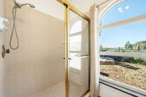 Bathroom with a stall shower and healthy amount of natural light