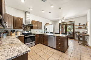 Kitchen with dark wood finish cabinets, stainless steel appliances, and a peninsula