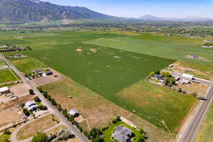 Aerial overview of property's location featuring a mountain backdrop and rural landscape