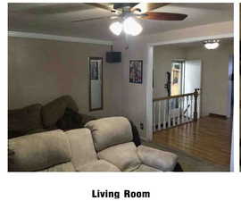 Living room with a ceiling fan and wood finished floors
