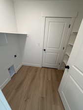 Laundry room featuring light wood finished floors and hookup for an electric dryer