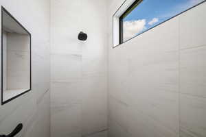 Full bathroom featuring tiled shower