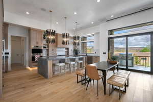Dining area featuring light wood-type flooring and a chandelier