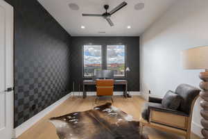 Office area with light wood-style flooring, a ceiling fan, an accent wall, and recessed lighting