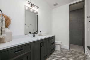 Full bath featuring a walk in shower and vanity