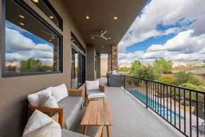 Balcony with view of pool and outdoor lounge area