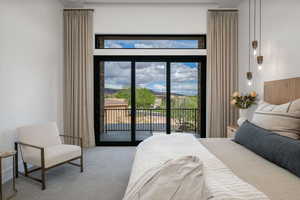 Bedroom with carpet floors and access to outside