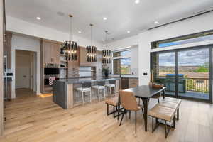 Dining space featuring light wood finished floors and hanging lights