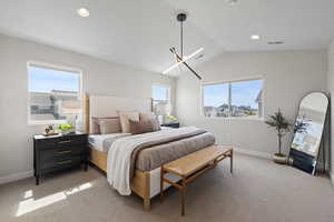 Master bedroom with vaulted ceiling, custom lighting, and tons of natural light