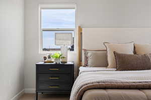Master bedroom with vaulted ceiling, custom lighting, and tons of natural light