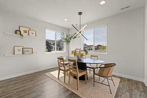 Push-out dining area with custom lighting, 9' ceilings, and sliding glass door to patio