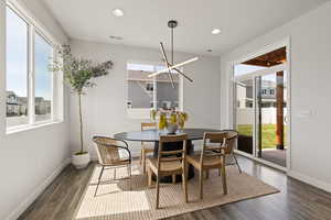 Push-out dining area with custom lighting, 9' ceilings, and sliding glass door to patio