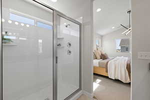 Master bath with quartz countertop, walk-in shower, and tile floors