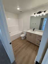 Full bath with vanity, light wood-type flooring, and bathing tub / shower combination