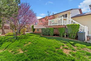 Back of house with a deck