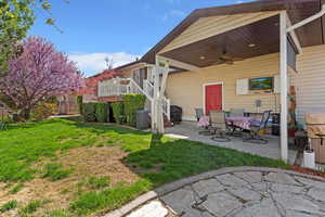 Rear view of house with a patio, ceiling fan, a yard, and a wooden deck