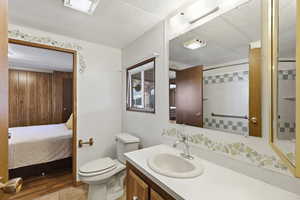 Full bathroom featuring a textured ceiling, vanity, curtained shower, and light tile patterned floors