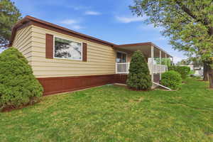 View of front facade featuring a front lawn and a porch