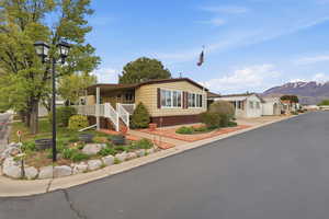Manufactured / mobile home with a mountain view, covered porch, and a residential view
