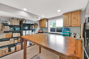 Kitchen featuring backsplash, recessed lighting, and light countertops