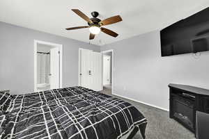 Bedroom featuring light carpet, ceiling fan, and connected bathroom