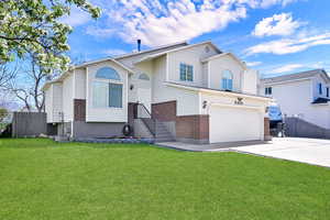 View of front of house with brick siding, an attached garage, and concrete driveway