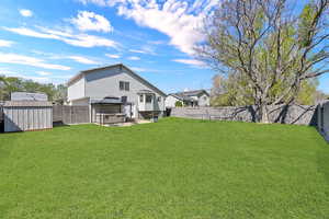 Back of house featuring a storage shed and a fenced backyard