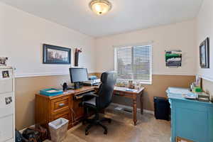 Office area with light carpet and baseboards