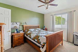 Bedroom featuring light carpet and ceiling fan