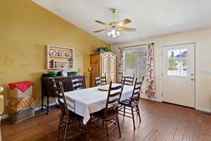 Dining space featuring wood finished floors, lofted ceiling, and ceiling fan