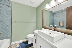 Full bath with vanity, tub / shower combination, and tile patterned floors