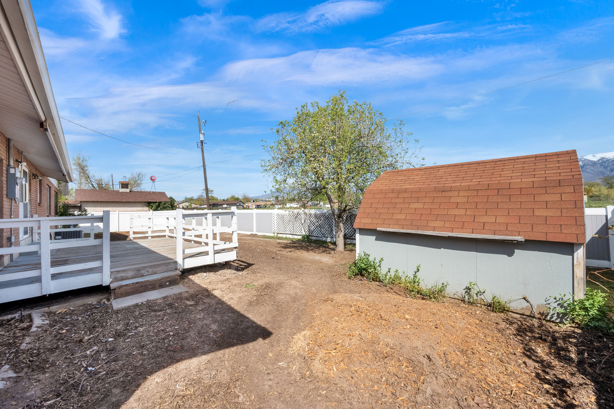 Fenced backyard featuring a deck