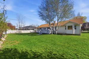 Rear view of property with a wooden deck and a chimney