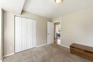 Unfurnished bedroom featuring a closet and light colored carpet